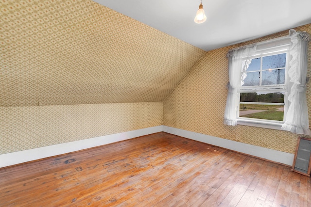 bonus room with lofted ceiling and wood-type flooring