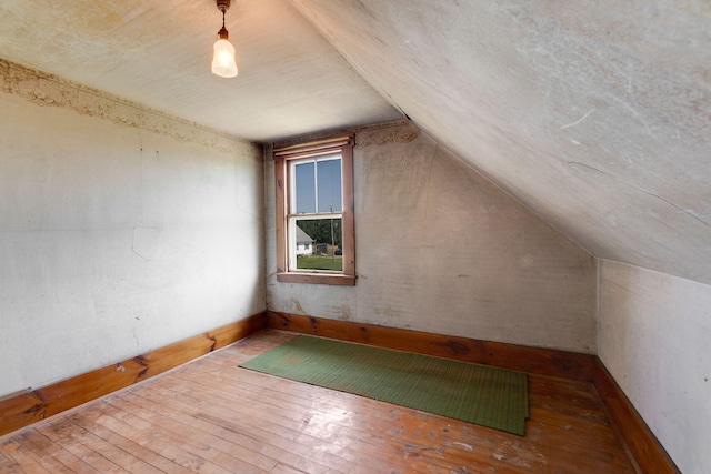 additional living space featuring hardwood / wood-style flooring and lofted ceiling