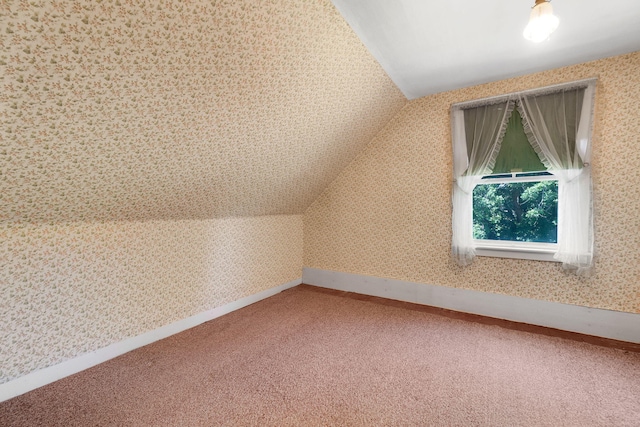 bonus room featuring lofted ceiling and carpet flooring