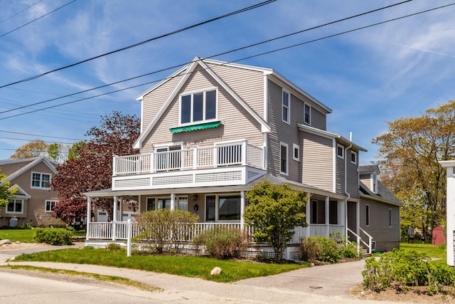 view of front facade featuring a balcony and covered porch