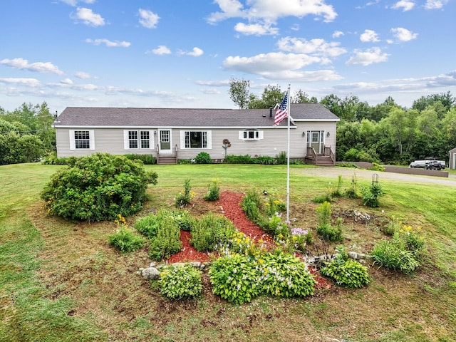 single story home featuring entry steps and a front lawn