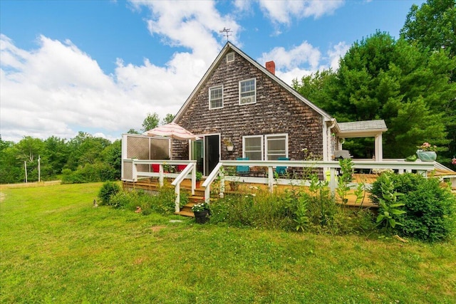 rear view of property featuring a yard