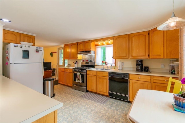 kitchen with pendant lighting, sink, black dishwasher, white refrigerator, and gas range