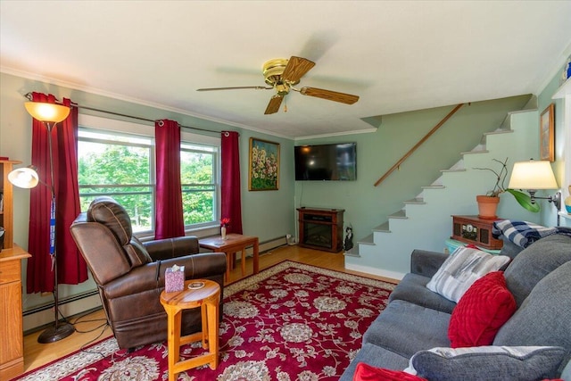 living room with crown molding, a baseboard radiator, ceiling fan, and light wood-type flooring