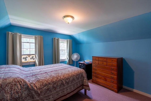 bedroom with carpet floors and vaulted ceiling