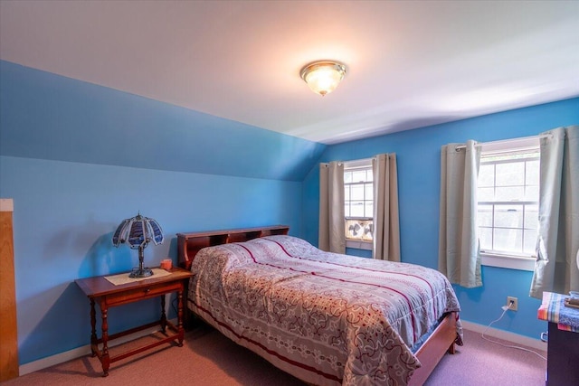 bedroom featuring lofted ceiling and carpet floors