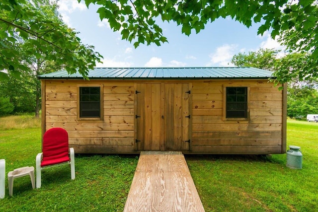 view of outbuilding featuring a yard