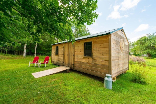 view of outbuilding with a lawn