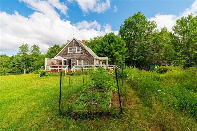 rear view of house with a yard