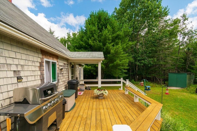 deck featuring area for grilling and a lawn