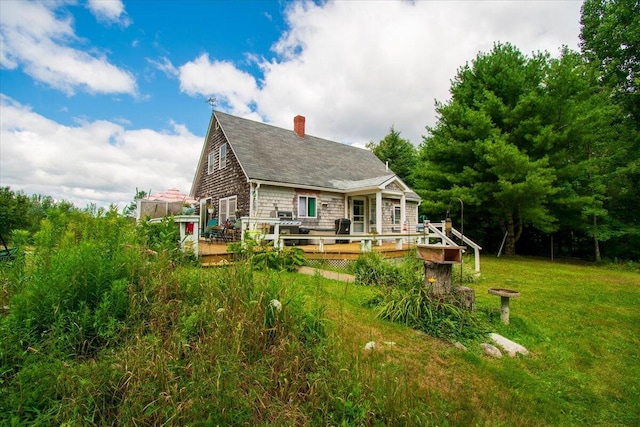 back of house featuring a yard and a deck