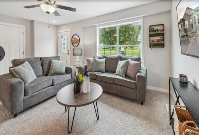 living area featuring carpet, ceiling fan, and baseboards