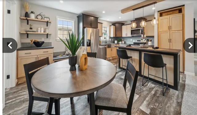 dining space featuring recessed lighting and wood finished floors