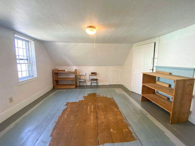 bonus room with lofted ceiling, wood-type flooring, and baseboards