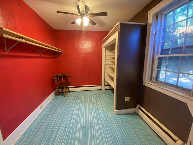 walk in closet featuring a baseboard radiator, a baseboard heating unit, ceiling fan, and carpet flooring