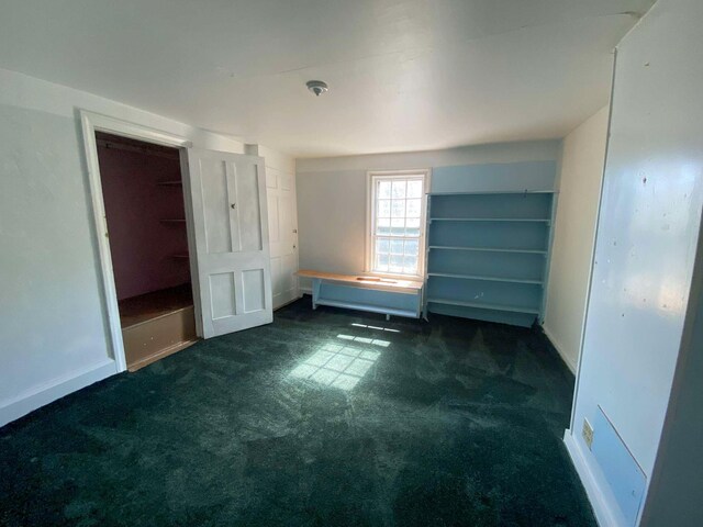 unfurnished bedroom with carpet floors and baseboards