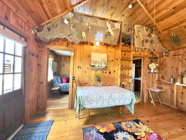 bedroom featuring wood finished floors, wood ceiling, and wooden walls