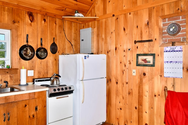 kitchen featuring electric panel, wood walls, sink, and white appliances