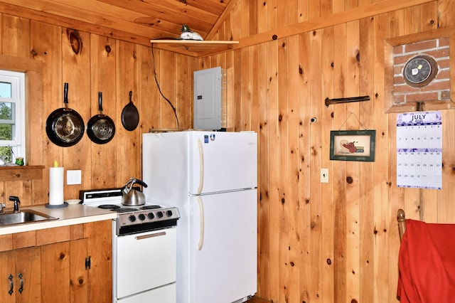 kitchen with light countertops, wood walls, a sink, white appliances, and electric panel