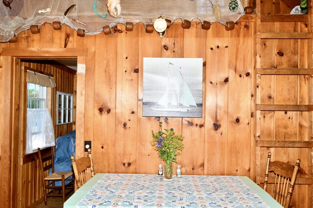 bedroom featuring wood walls