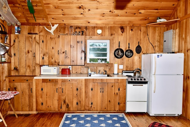 kitchen featuring white appliances, wood finished floors, wood ceiling, light countertops, and electric panel