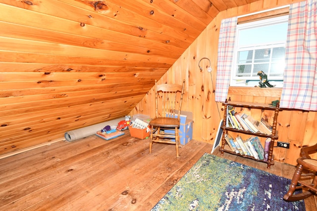 bonus room with wooden ceiling, wood walls, wood finished floors, and lofted ceiling