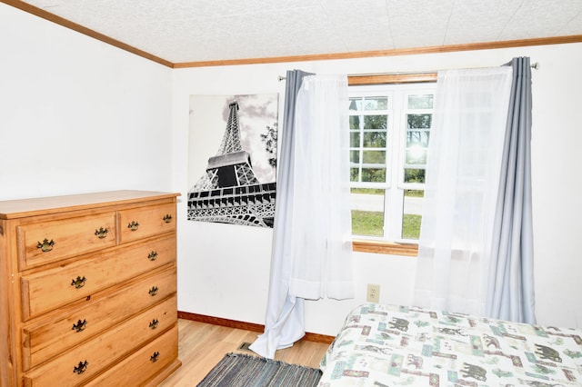 bedroom with light wood-type flooring, multiple windows, crown molding, and baseboards