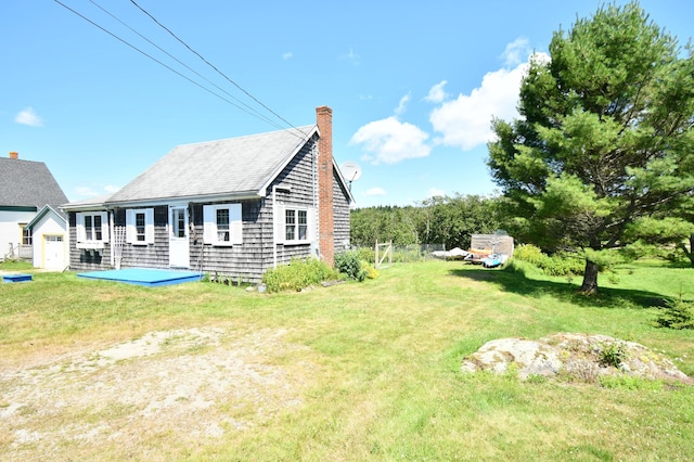 exterior space featuring a yard and a chimney