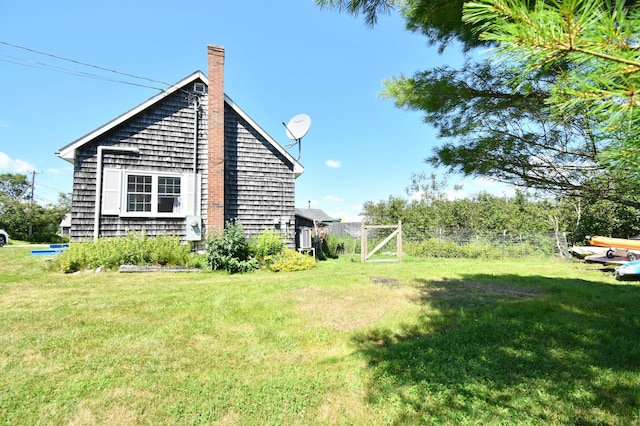 view of home's exterior with a lawn and a chimney