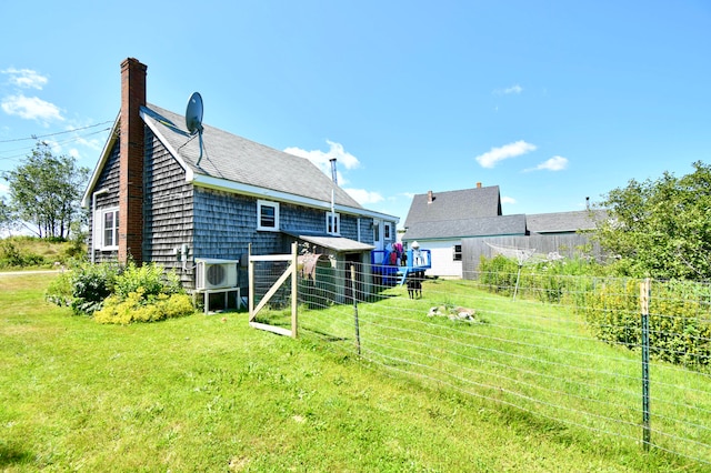 back of house featuring a lawn