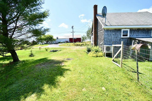 view of yard featuring ac unit and fence