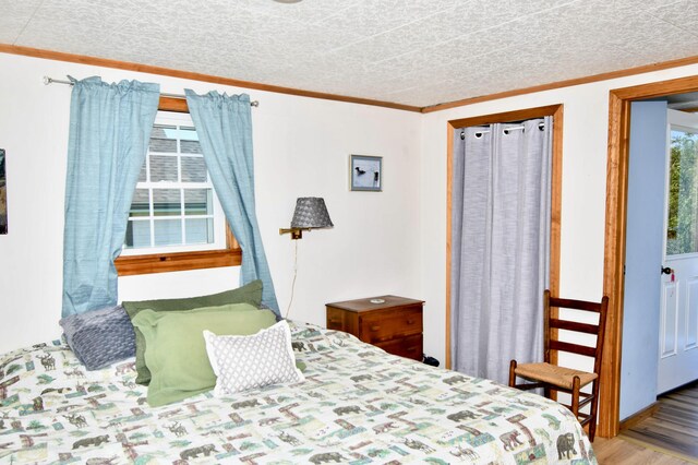 bedroom featuring ornamental molding and hardwood / wood-style flooring