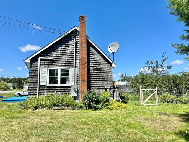 view of side of home featuring a lawn