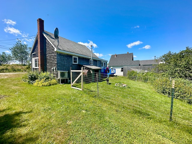 rear view of property featuring a yard