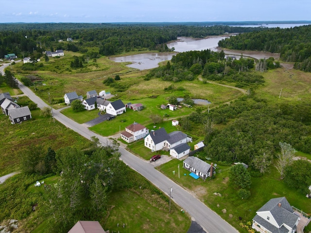 bird's eye view featuring a water view, a residential view, and a wooded view