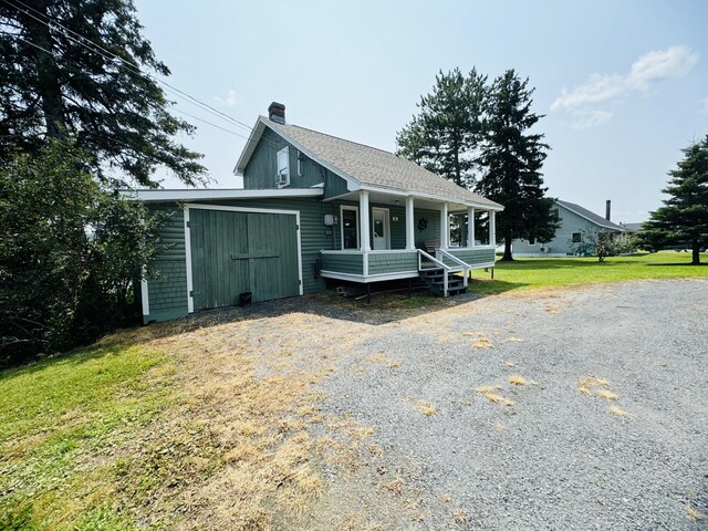 view of front of house with a porch and a front lawn