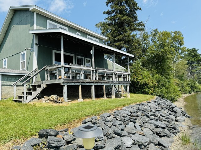 rear view of property featuring a yard