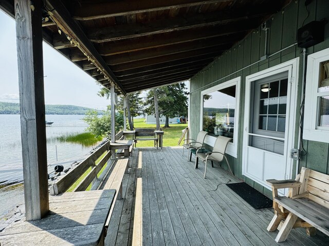 wooden deck featuring a water view