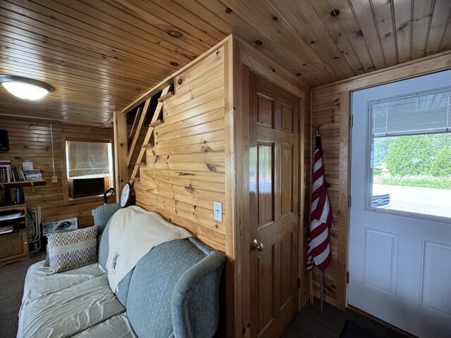 interior space with cooling unit, wooden ceiling, and wooden walls