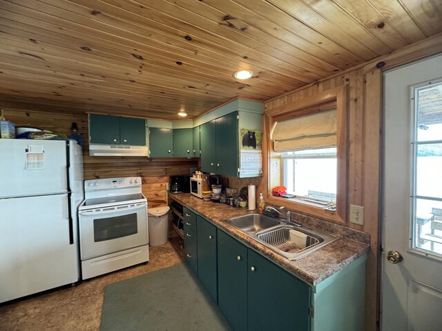 kitchen featuring wood walls, green cabinetry, a healthy amount of sunlight, and white appliances