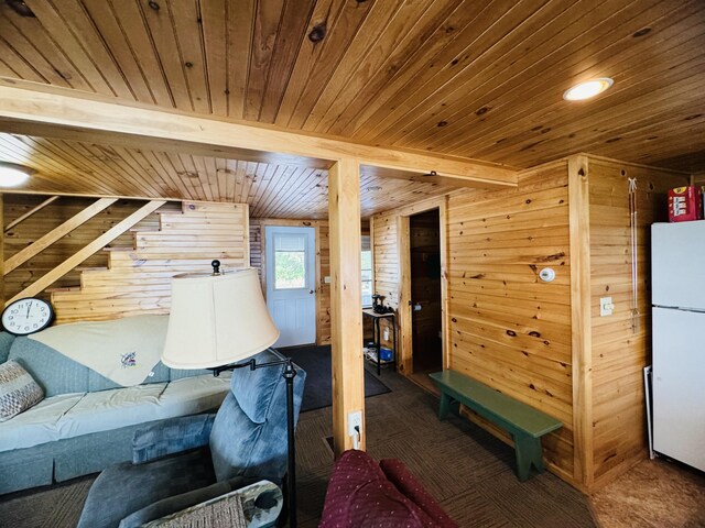 interior space with carpet floors, wood walls, white fridge, and wooden ceiling