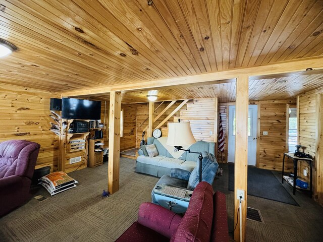 carpeted living room with wooden ceiling and wooden walls