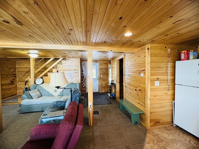 interior space featuring beamed ceiling, wooden walls, and wood ceiling