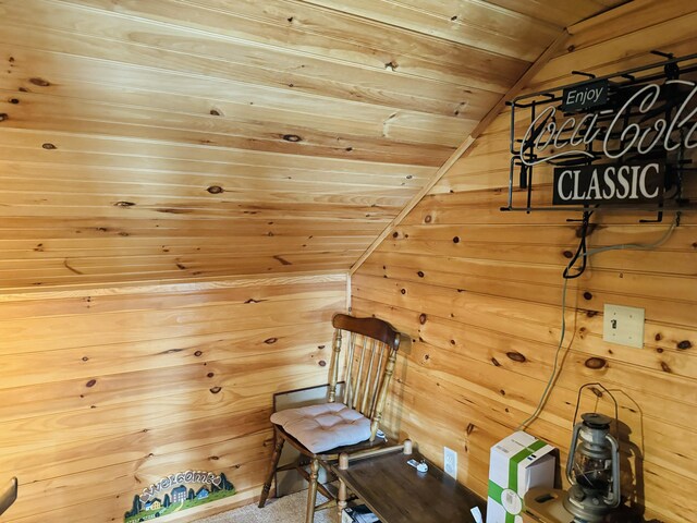 sitting room featuring wood walls, vaulted ceiling, and wood ceiling