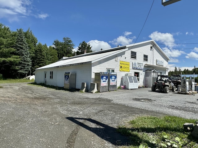 view of side of property with metal roof