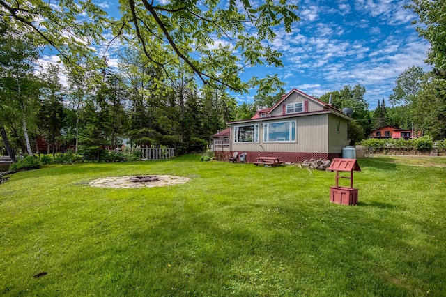 view of yard with a fire pit