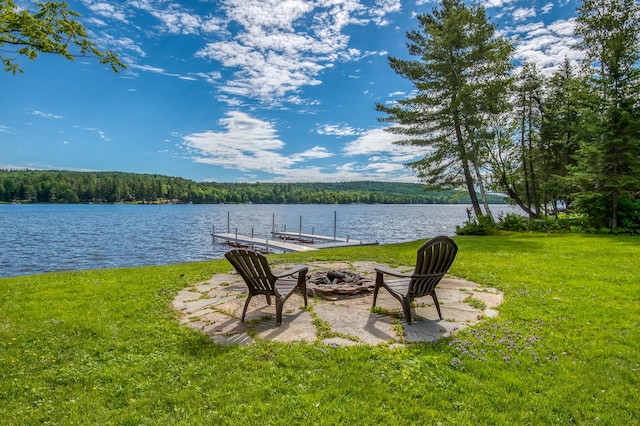 view of yard featuring a dock and a water view