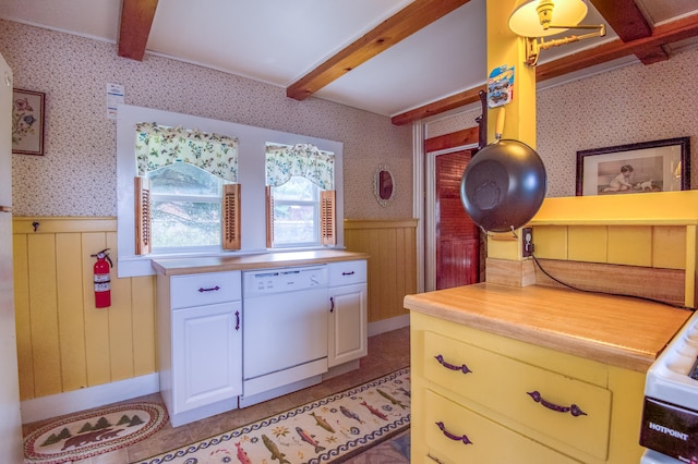 kitchen with beam ceiling, white dishwasher, and white cabinets