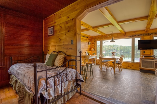 bedroom featuring wood walls, beamed ceiling, tile patterned floors, and coffered ceiling