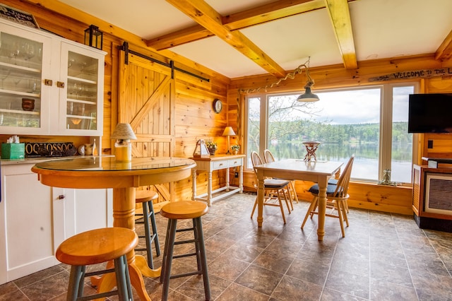 tiled dining area with coffered ceiling, a barn door, and beam ceiling